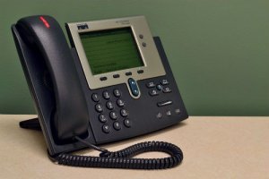 A desk phone with a blinking red light